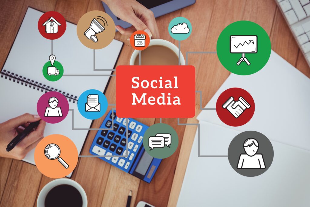 digital composite of hands using notebook with graphics of social channels